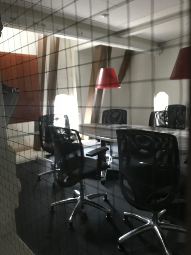 Locked Private Conference Room With Table And Chairs