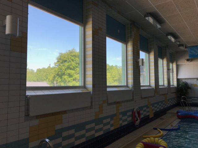 Large Lined Up Windows In Inhouse Pool Area With Toys