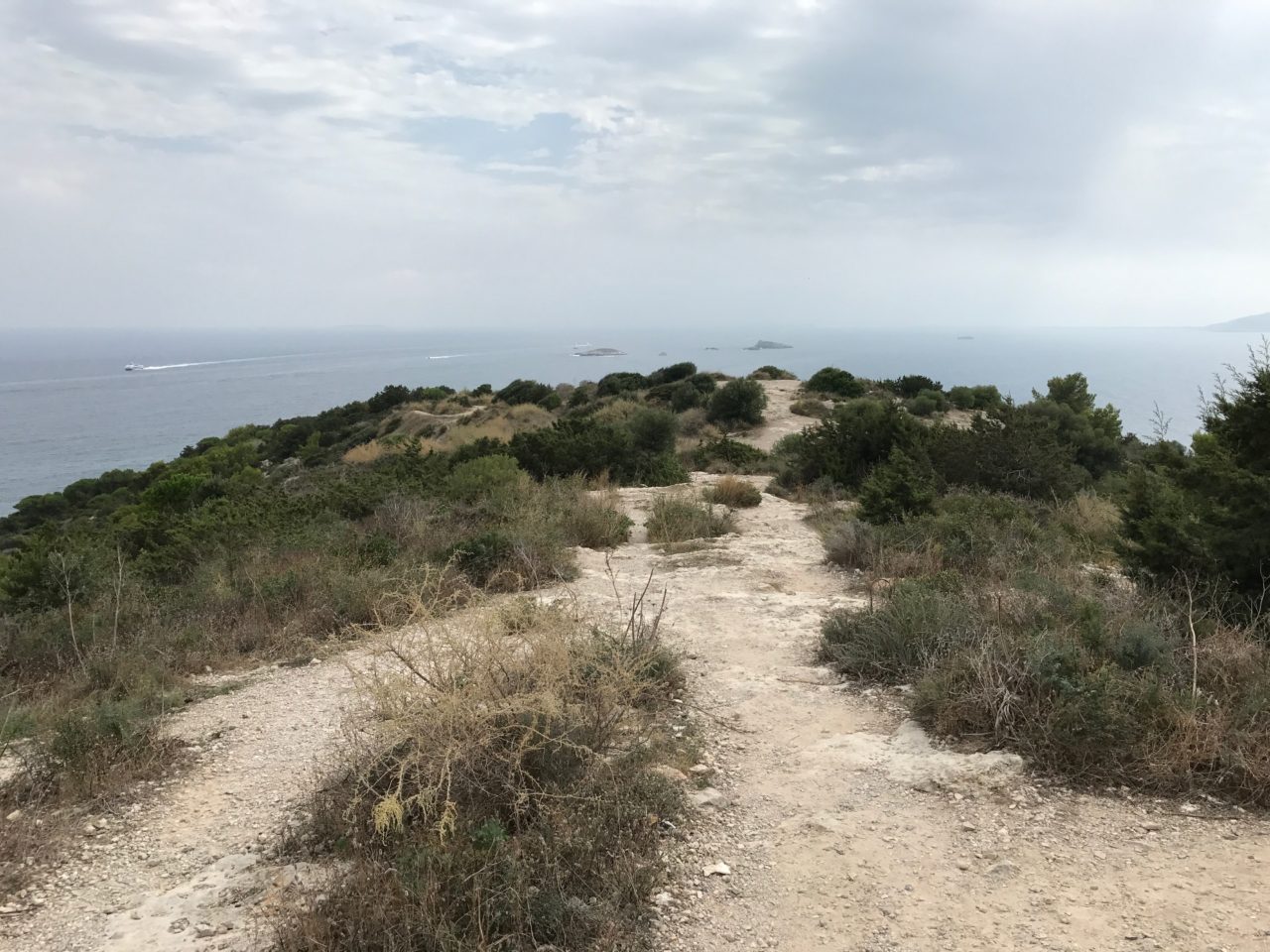 Mountain Dirt Pathway With Brush And Grass By The Ocean