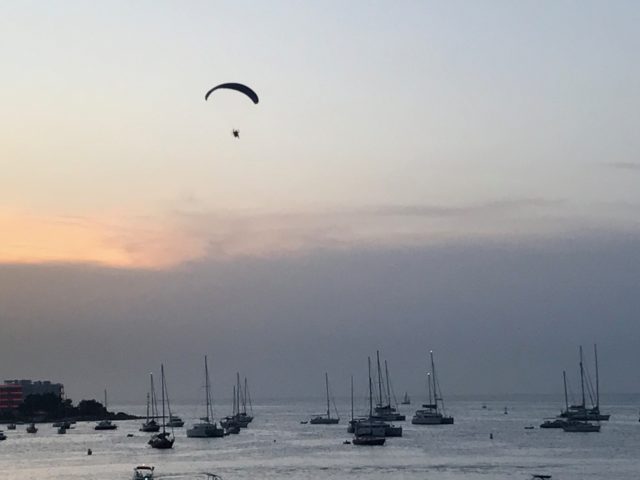 Paraglider Flying In The Sky At Cloudy Sunset