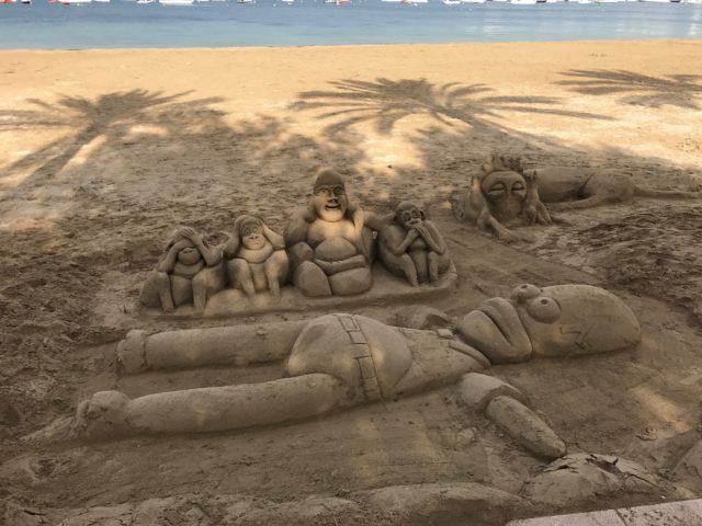 Simpsons And Monkey Sand Sculpture Art On Beach