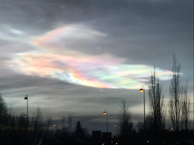 Aurora Borealis Phenomena In The Cloud-Filled Sky