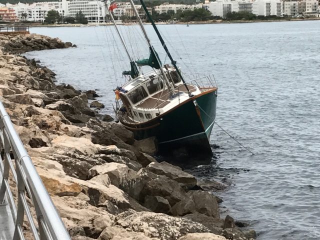 Stranded Boat On A Pier Bank In A Harbor