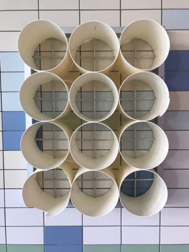 Storage Pipes Mounted On Tiled Wall
