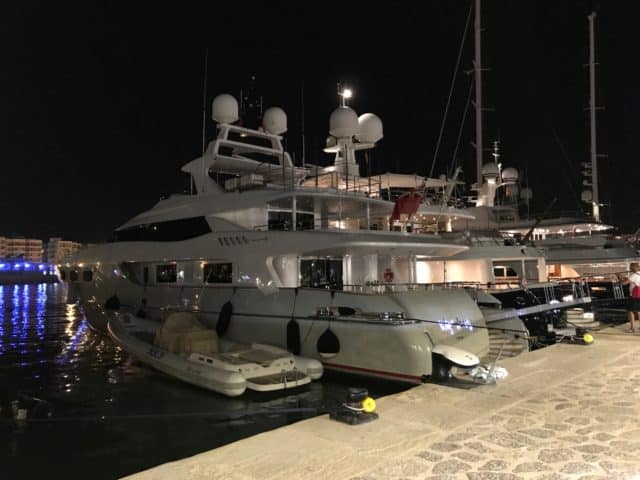 Lyxury Yacht At Dock With Small Boat By Its Side