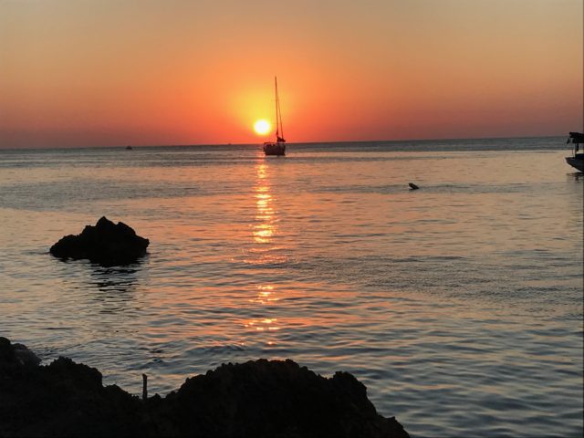 Orange Ocean Sunset With Sailing Boat