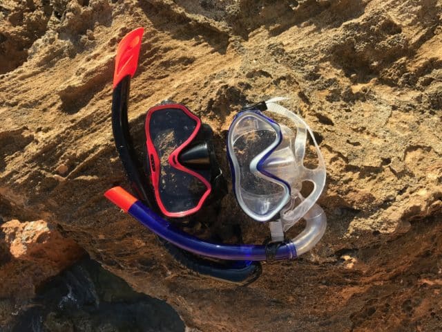 Diving Goggles And Gear On Cliff