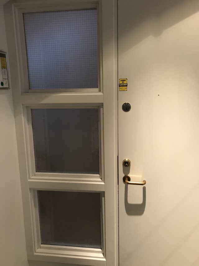 Closed White Door With Frosted Fireproof Square Windows