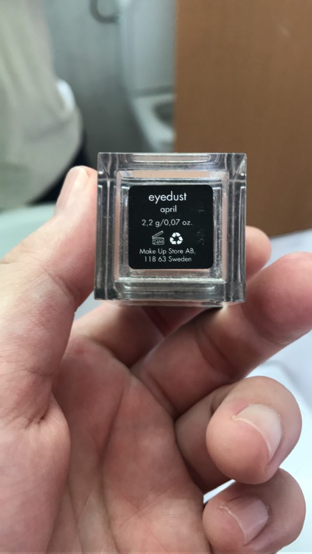 Hand Holding Eyedust Makeup Package