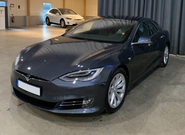 Gray Tesla Model S With A Model X In The Background In Showroom