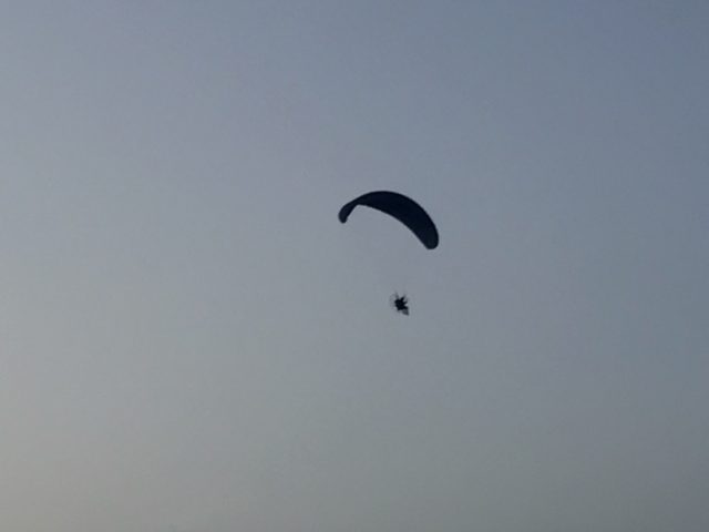 Skydiver Flying In A Clear Blue Sky Evening