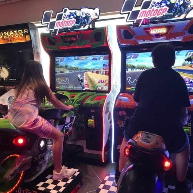 Children Compete In Motorcycle Games In Gaming Hall