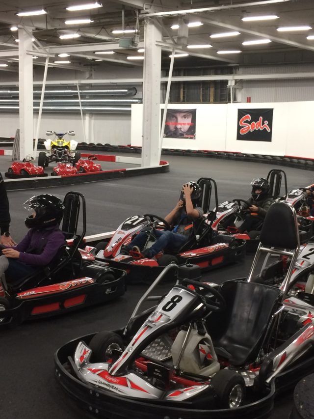 Young People Go Go-Karting On An Indoor Track