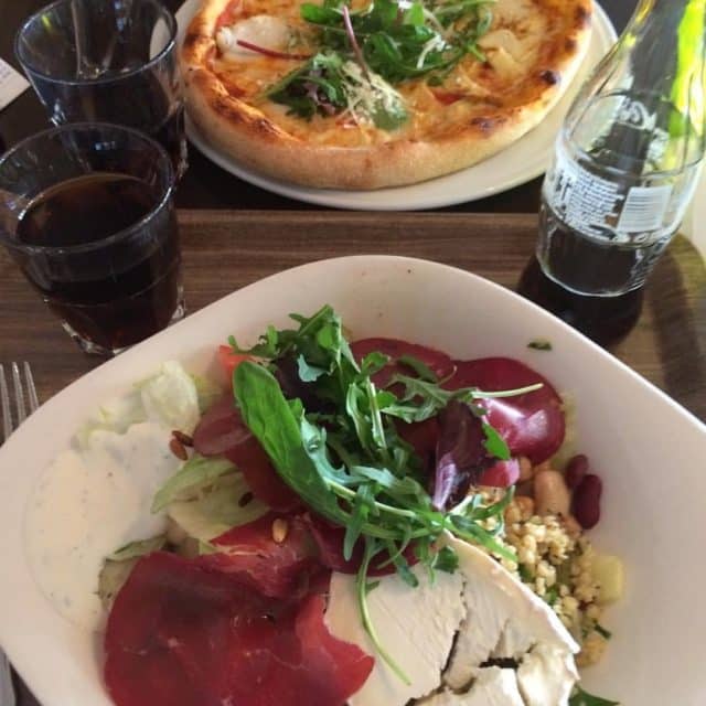 Pizza On White Plate And Salad With Goat Cheese And Coca Cola