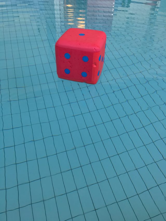 Floating Dice With Blue Dots In The Exercise Pool