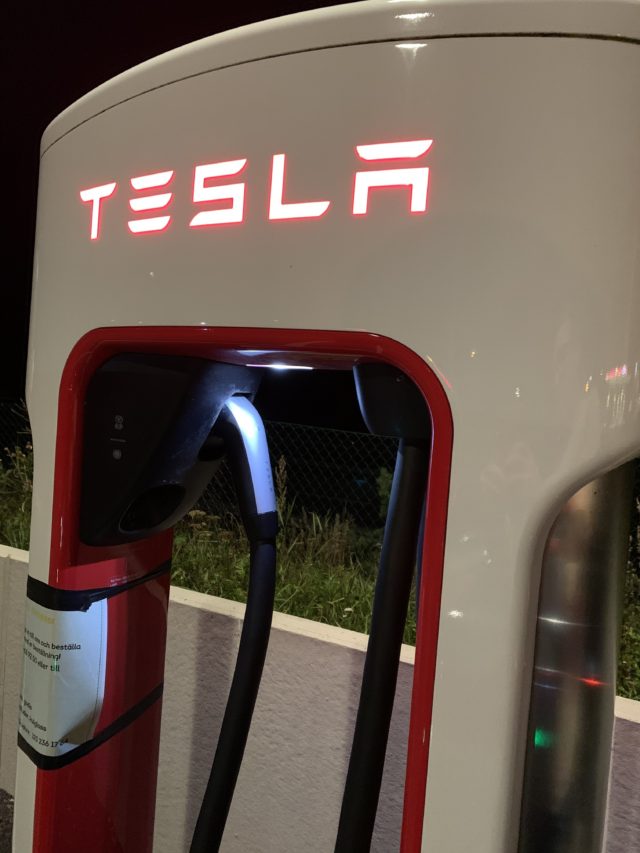 Tesla Supercharger Stall Station Glowing Sign And Charger Cord