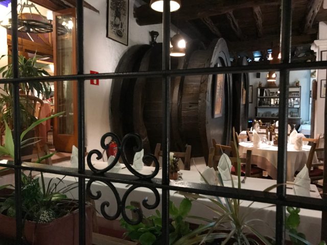 Looking Through Window Into Restaurant With Beer Barrels And Tables