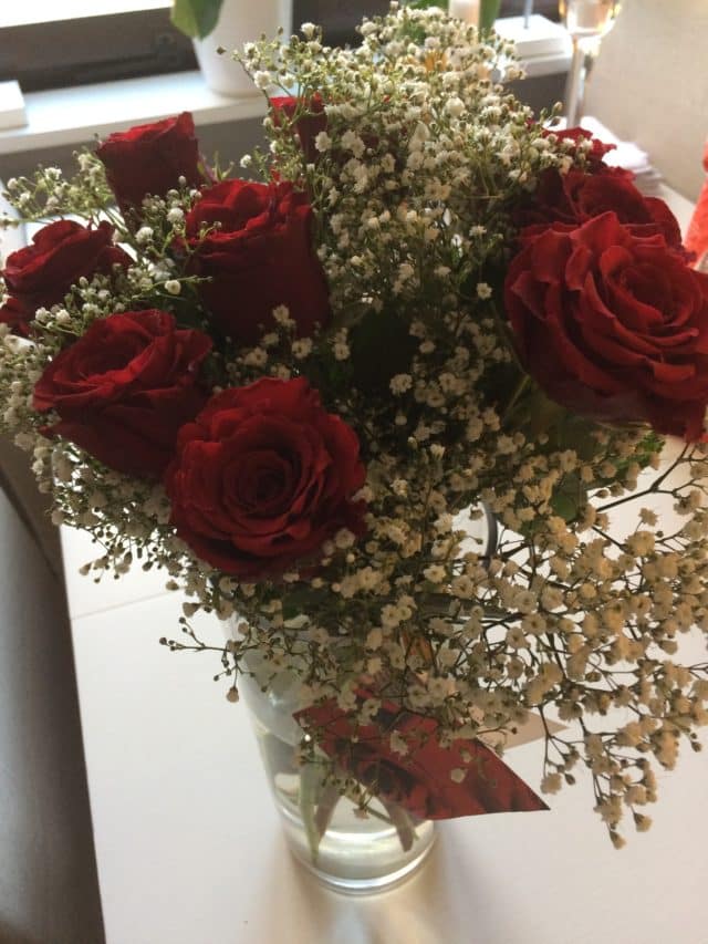 Bouquet Of Red Roes In A Vase On A Table