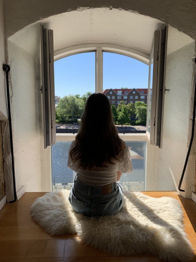 Girl Sitting By An Open Window Watching The View