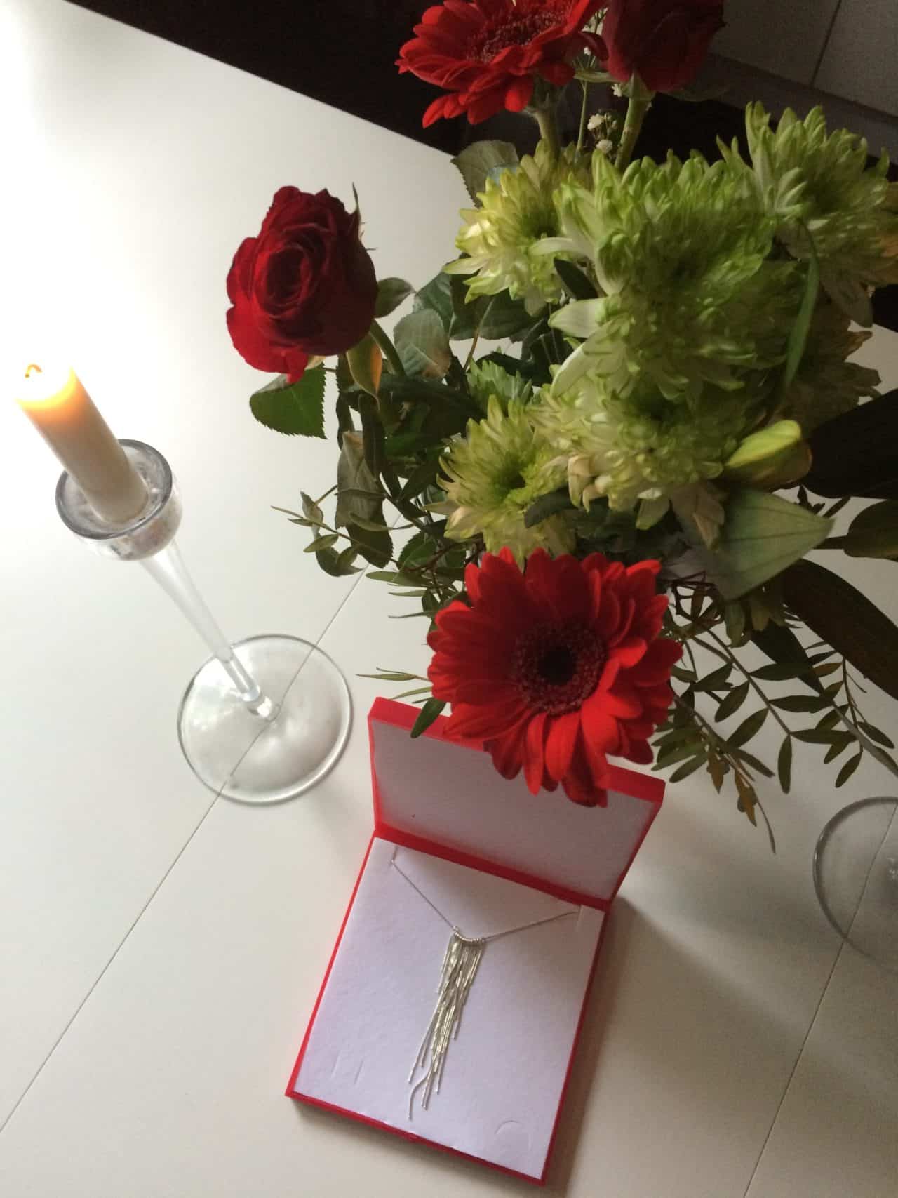 Jewelry Gift With Flowers And A Lit Candle
