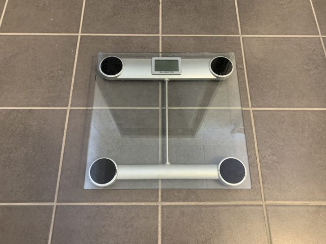 Glass Weight Scale On Bathroom Floor