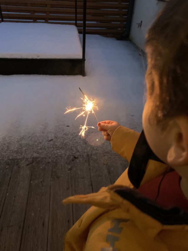 Child Holding Sparkler On New Years Eve