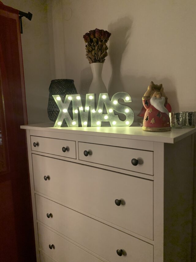 Christmas Ornaments And Xmas Text Lamp On Drawer