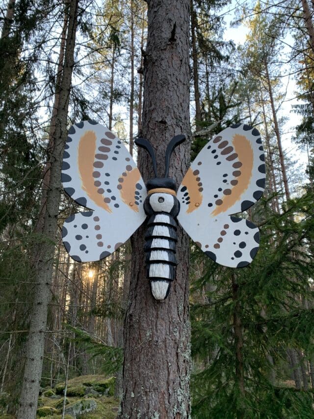 Giant Wooden Butterfly Mounted On A Tree In The Forest