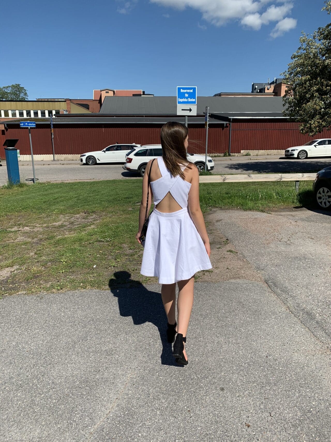 Girl Walking To Graduation In White Dress