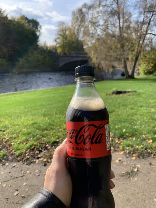 Hand Holding A Coca Cola Soda Bottle