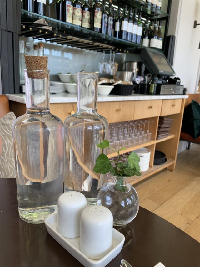 Hotel Restaurant Table Setup With Glass Bottles