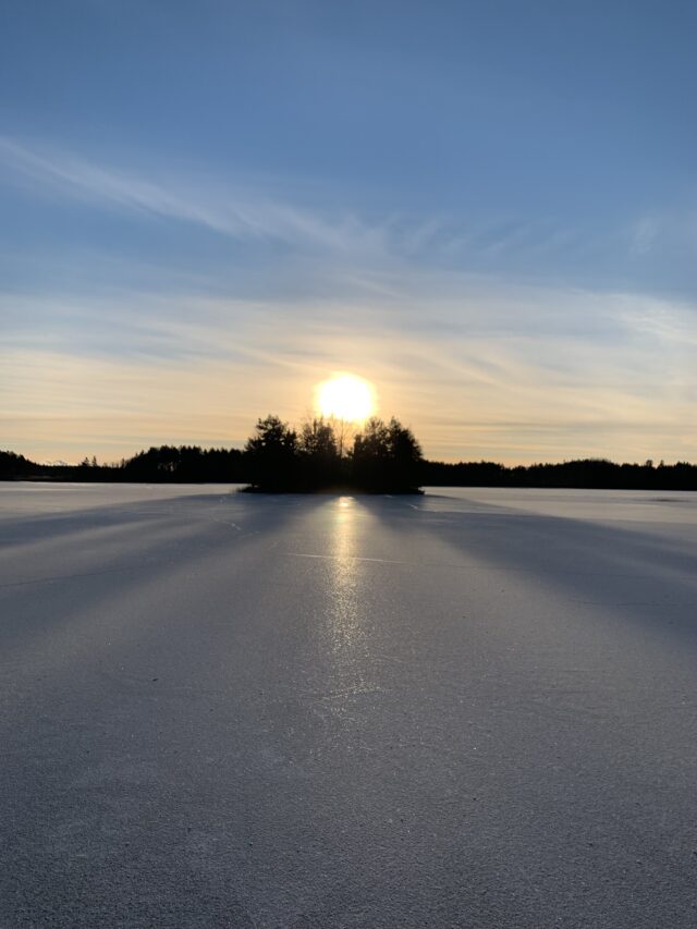 Sunset Behind Island In Frozen Lake In Winter