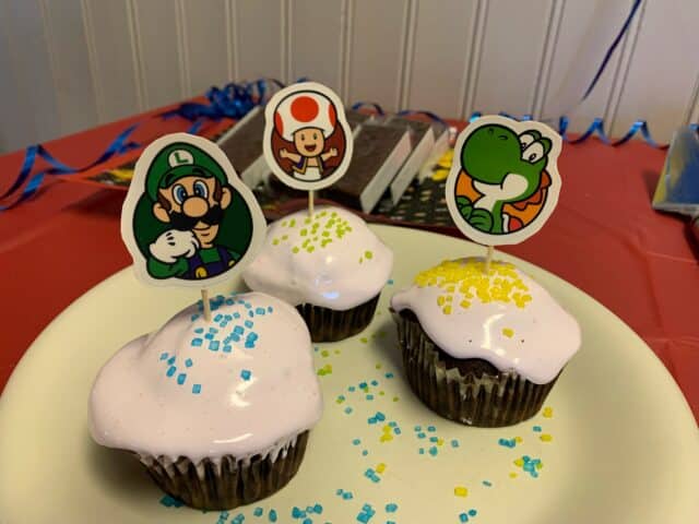 Cupcakes With Pink Icing And Characters From Super Mario