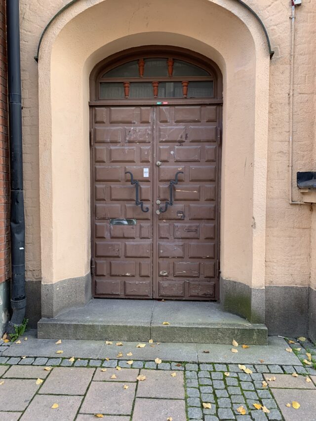 Old Wooden Door Entrance On A Cobblestone Street