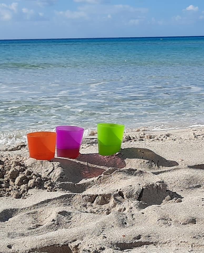 Mugs In The Sand By The Blue Water