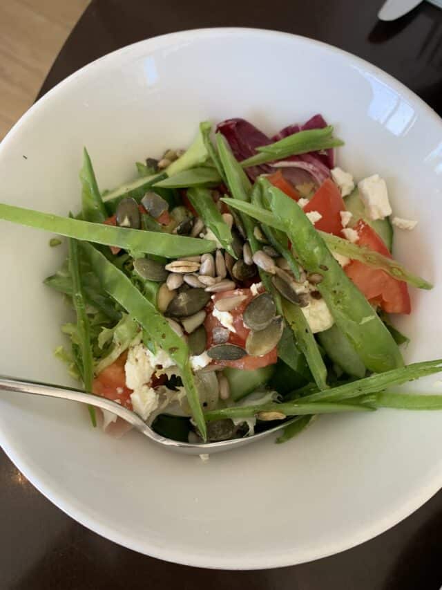 Vegetable Salad With Nuts And Feta Cheese In White Bowl