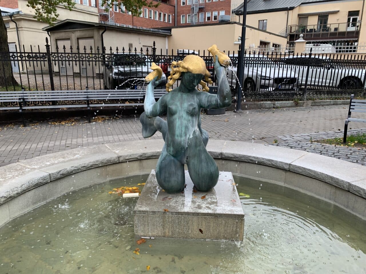 Bronze And Gold Woman Statue In A Fountain