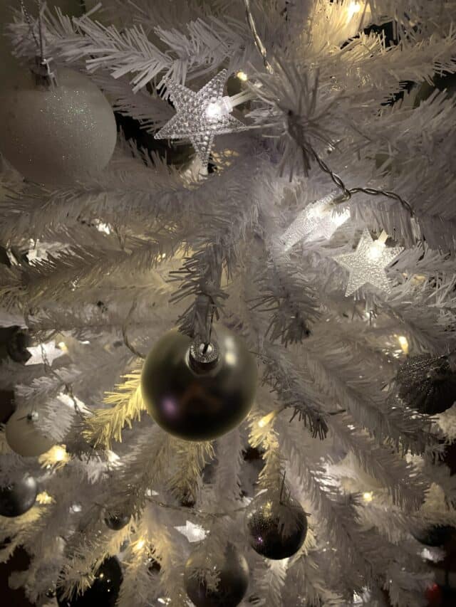 White Christmas Tree With Silver And Glitter Baubles And Star Lights