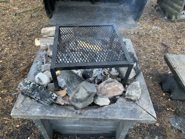 Wilderness Camp Site Fireplace Barbecue Grate With Smoke